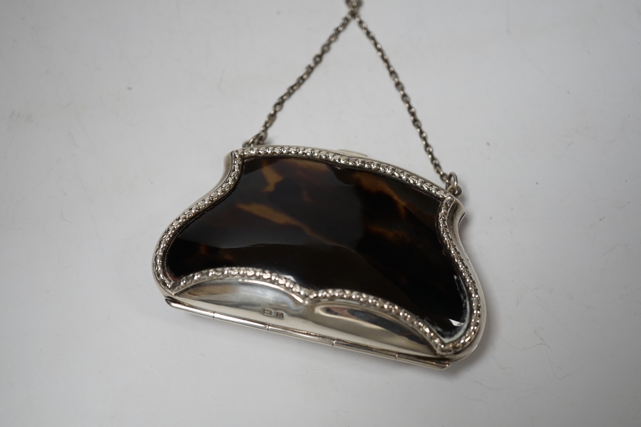 A George V silver and tortoiseshell purse, with suspension chain, E.S. Barnsley & Co, Birmingham, 1912, width 9cm.